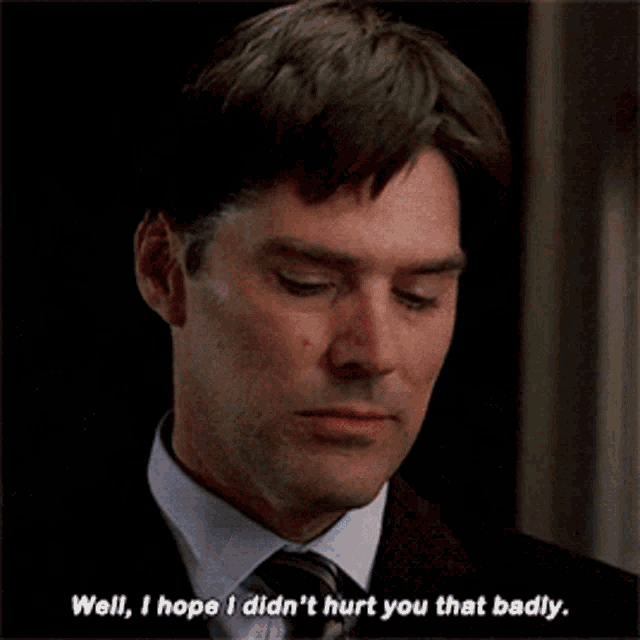 a man in a suit and tie is saying well i hope i didn 't hurt you that badly