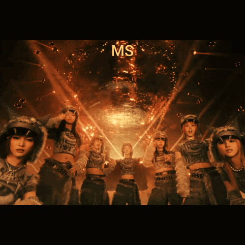 a group of female dancers are standing in front of a large ms sign