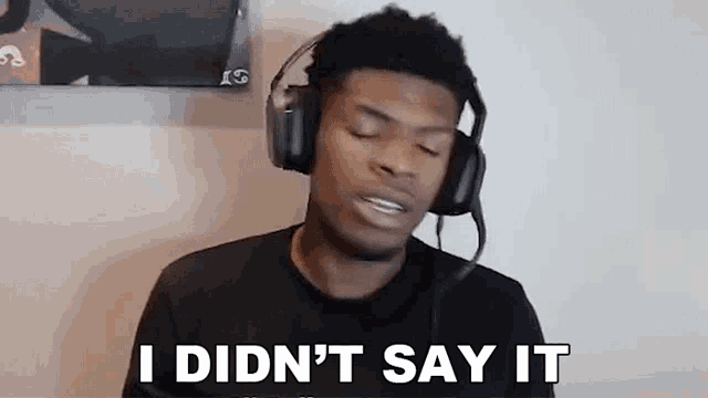 a young man wearing headphones is making a funny face and saying `` i didn 't say it '' .