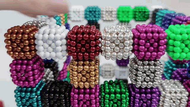 a bunch of different colored beads are stacked together