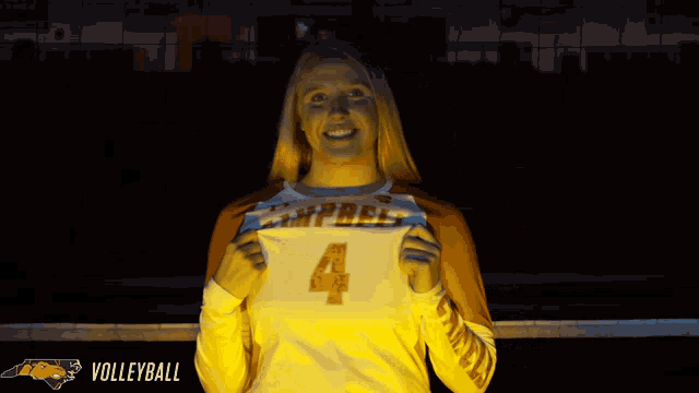 a woman wearing a volleyball jersey with the number 4