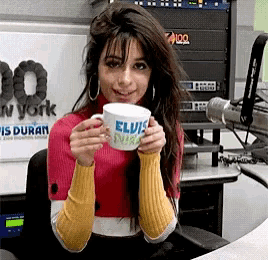 a woman holding a mug that says elvis presley on it