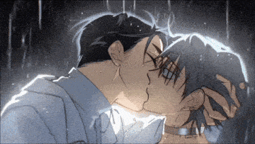 a man and woman kissing in the rain with the man holding the woman 's head