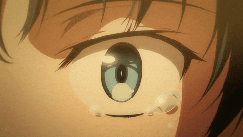 a close up of a person 's eye with tears running down it