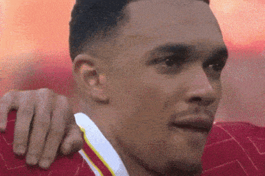 a close up of a man 's face with a person 's hand on his shoulder