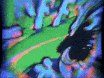 a blurry picture of a person 's face with a purple and green background