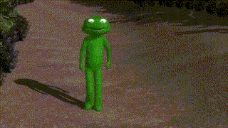 a green frog is standing on a dirt road