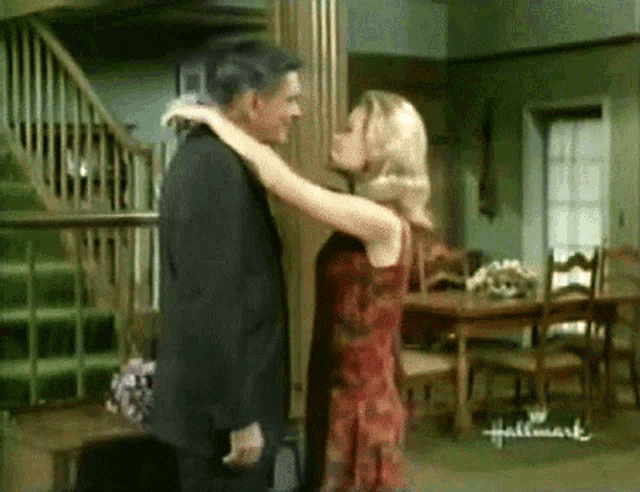 a man and a woman are hugging in a hallmark advertisement