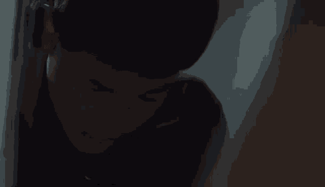 a close up of a person 's face in the dark .