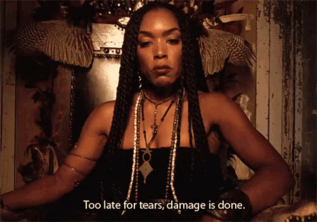 a woman with dreadlocks is sitting on a throne with the words too late for tears damage is done below her