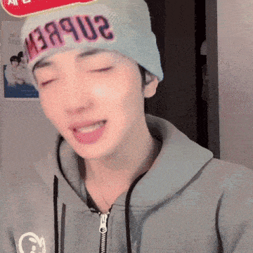 a man wearing a beanie that says ' 2n8bew ' on it