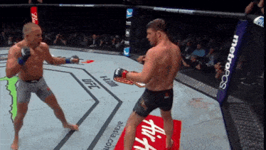 two men are fighting in a ring with a metropcs banner