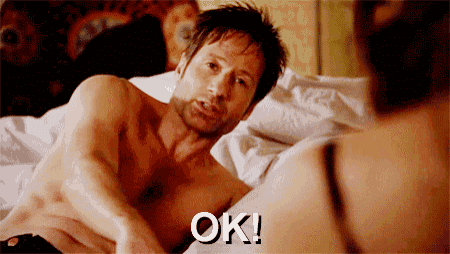 a shirtless man laying on a bed with the word ok written on the bottom
