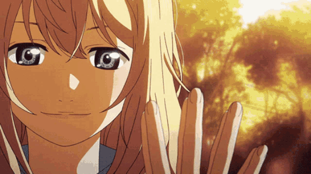a close up of a girl 's face with her hands outstretched