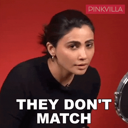 a woman is looking at herself in the mirror and says they don 't match .