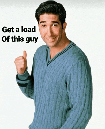 a man in a blue sweater is giving a thumbs up with the words get a load of this guy behind him
