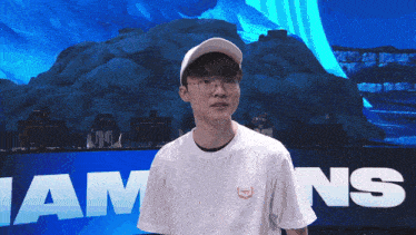 a man wearing glasses and a white hat stands in front of a sign that says i am ns