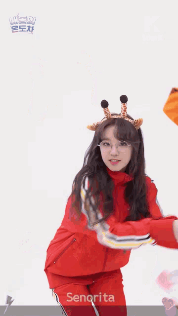 senorita is wearing glasses and a headband with giraffe horns