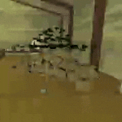 a blurry picture of a room with a ceiling fan in the background