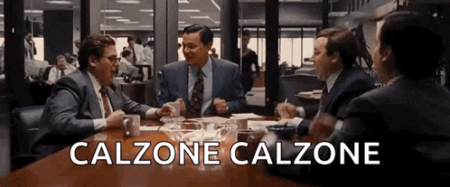 a group of men are sitting at a table with the words calzone calzone written on the table