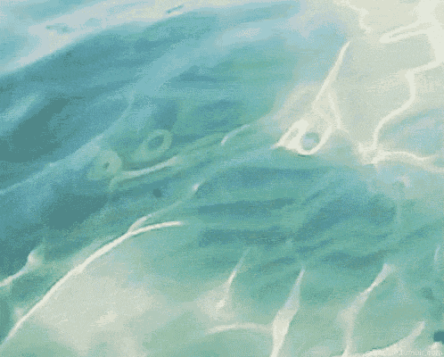 a close up of a blue water surface with a website url at the bottom of the image