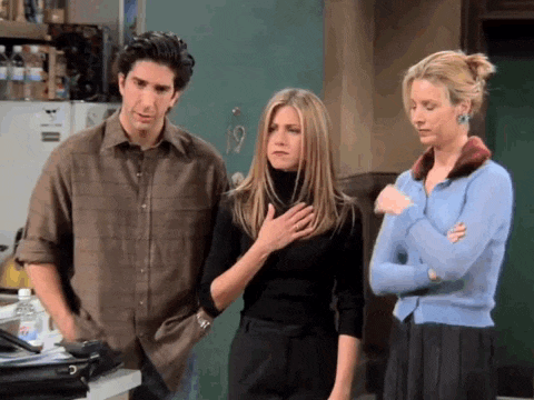 a man and two women are standing next to each other .