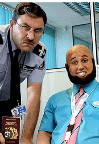 a man in a blue shirt and pink tie is holding a passport