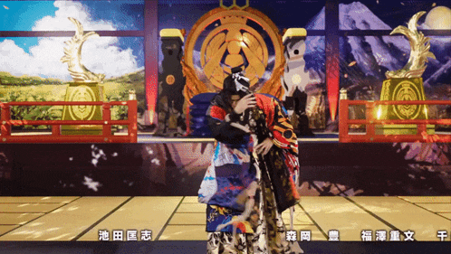 a man in a kimono stands in front of a statue with chinese writing on it