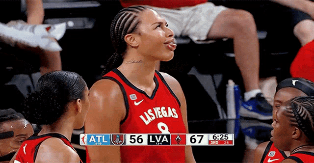 a basketball player wearing a las vegas jersey sticks out her tongue