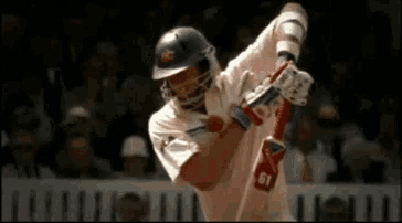 a cricket player wearing a white jersey with the number 01 on it