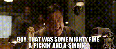 a man in a suit says boy that was some mighty fine a-pickin and a-singin .