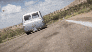 a silver van is driving down a road with a license plate that says ' jc ' on it