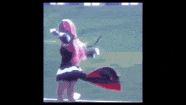 a blurry picture of a woman with pink hair holding a red object