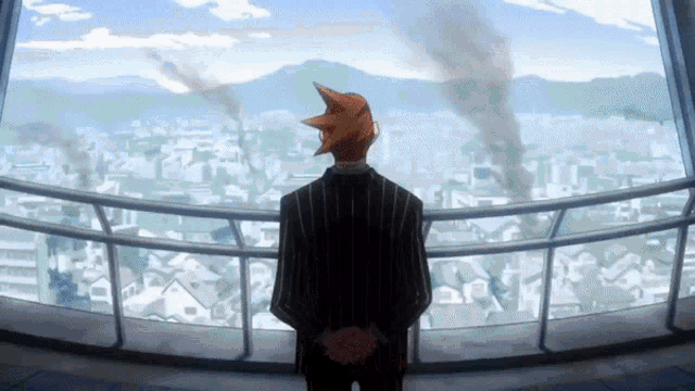 a man in a striped suit stands on a balcony looking out over a city