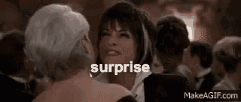 a woman is dancing with another woman in a crowd and the word surprise is written above her .