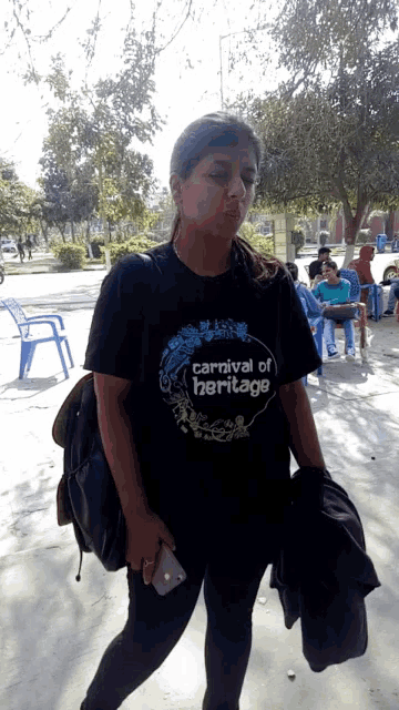 a woman wearing a carnival of heritage t-shirt