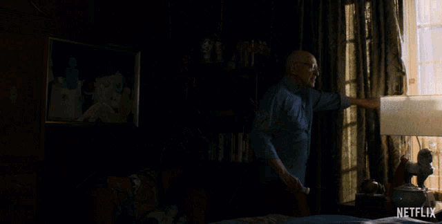 a man is standing in a dark room with a netflix logo on the bottom right