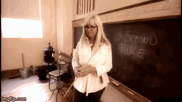 a woman stands in front of a chalkboard that says 3 second rule