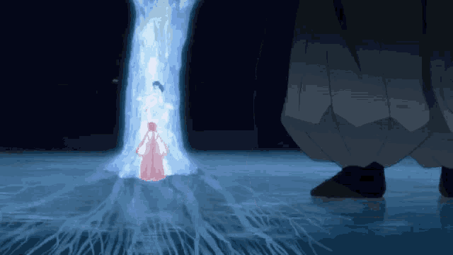 a woman in a red dress is standing in front of a tree in the water