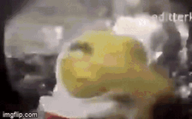 a close up of a yellow object that looks like a spongebob squarepants character .