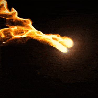 a dark background with a flame coming out of the middle