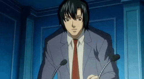 a man in a suit and tie is standing in front of a podium with two microphones .