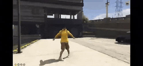 a man in a yellow shirt and shorts is standing on a concrete surface in a video game .