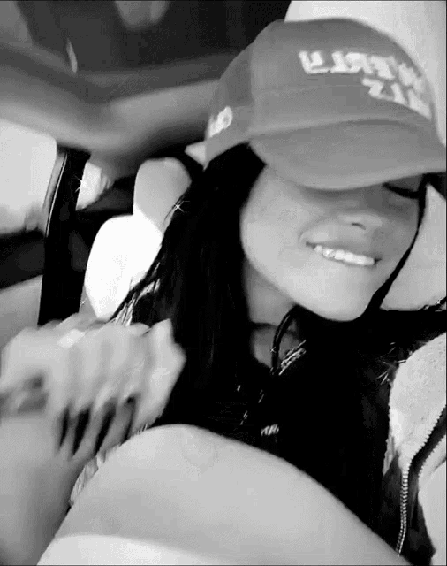 a black and white photo of a woman wearing a hat that says u.s. army