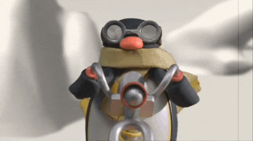 a penguin wearing goggles and a scarf is standing in front of a white background