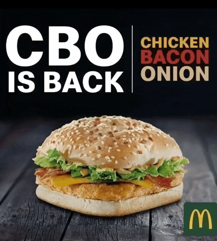a chicken bacon onion sandwich is on a wooden table