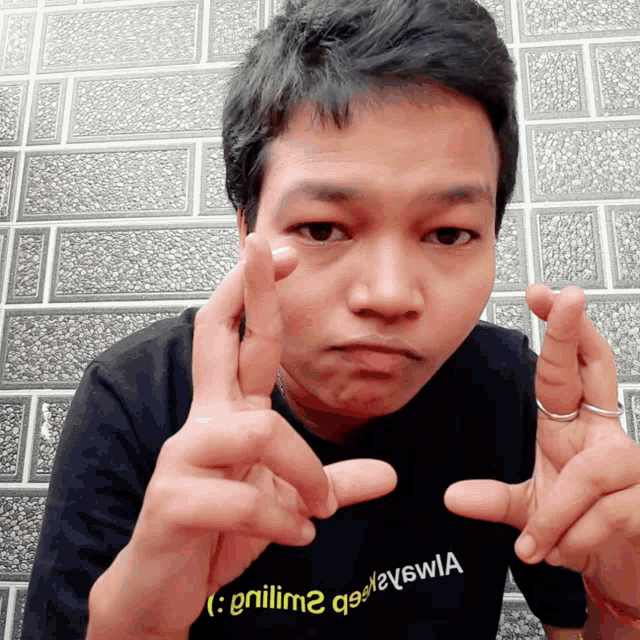a man wearing a shirt that says " grillim2 " is making a funny face