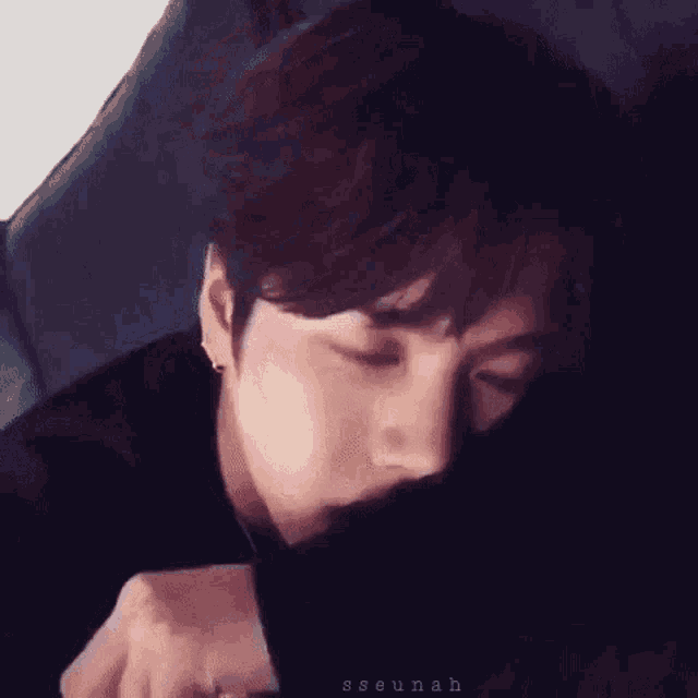 a close up of a person sleeping on a couch .