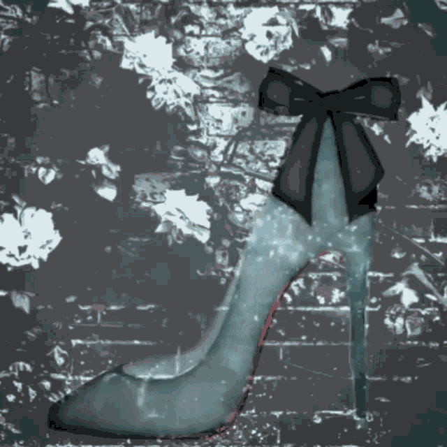 a blue shoe with a black bow on the back