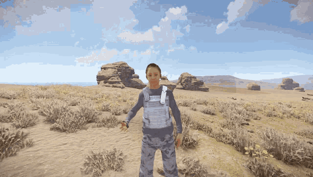 a man in a military uniform stands in a desert landscape